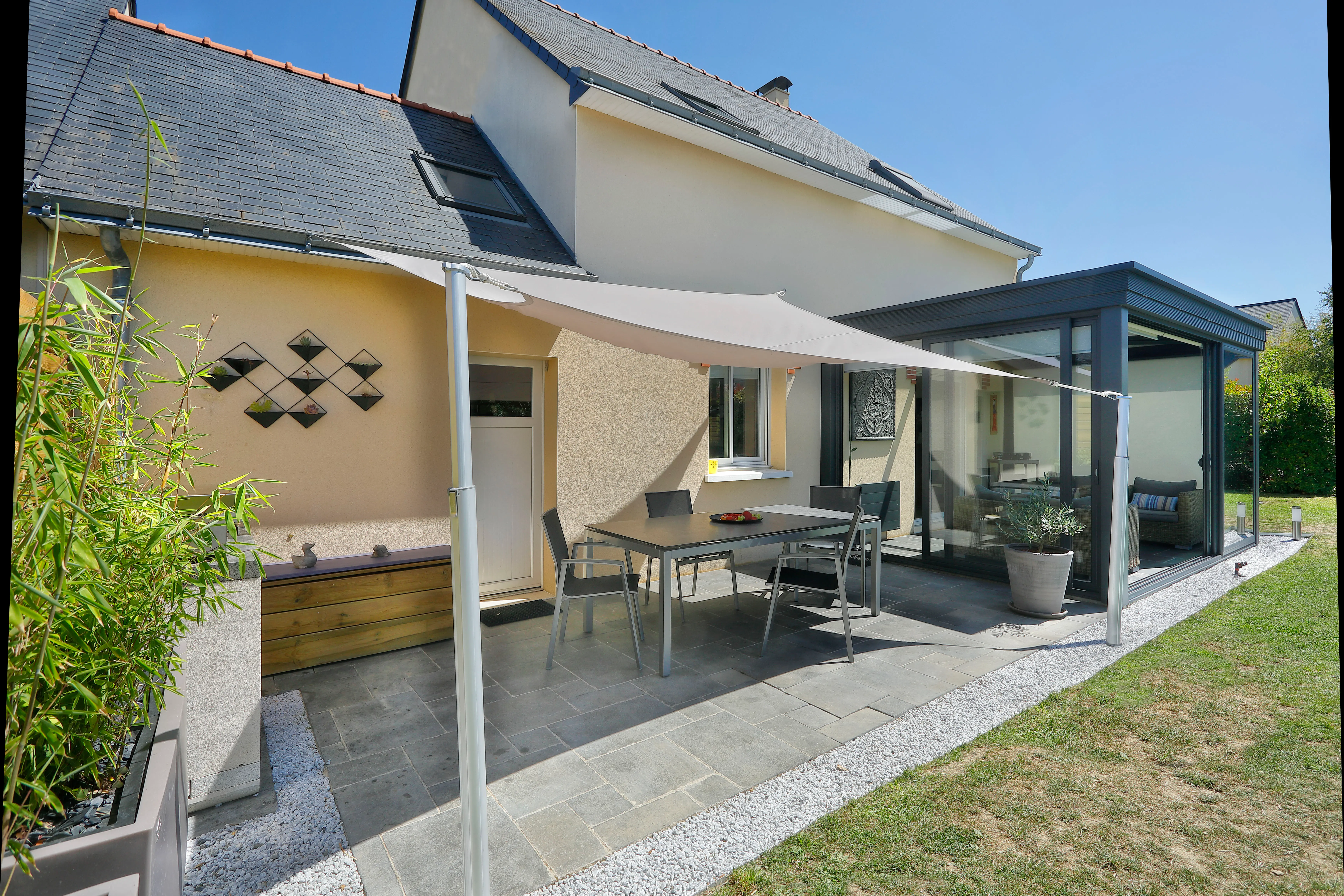 Shade sail protecting a dining area from harmful sun rays