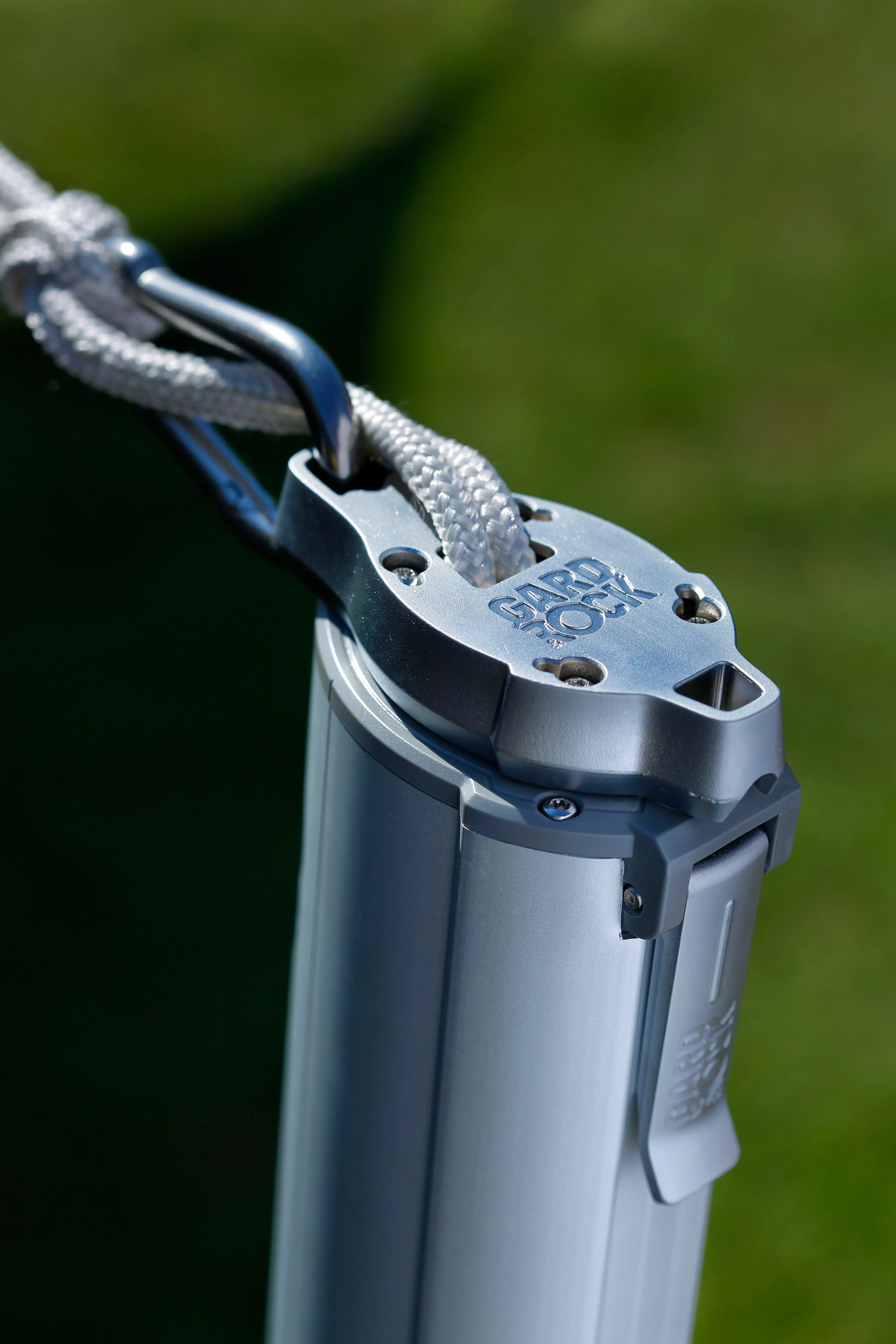 Shade sail attached to the pole with a carabiner, cord neatly stored inside