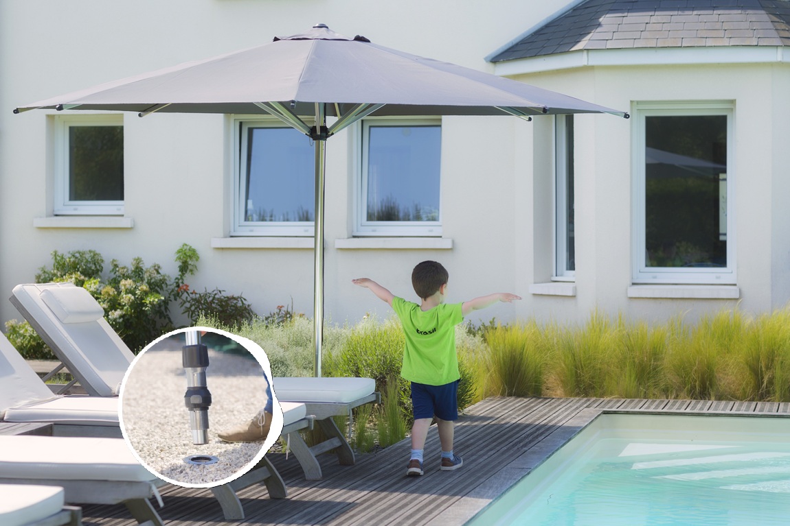 Shade from a straight parasol over a sun lounger by the pool