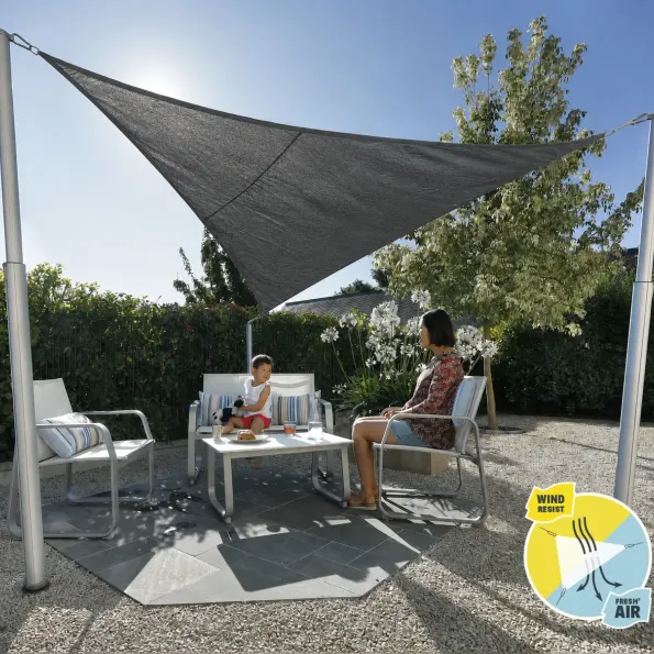 Shade canopy installed on terrace, creating a stylish shaded area for outdoor dining.
