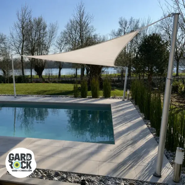 Shade sail stretched above a pool, offering sun protection and creating an elegant atmosphere.